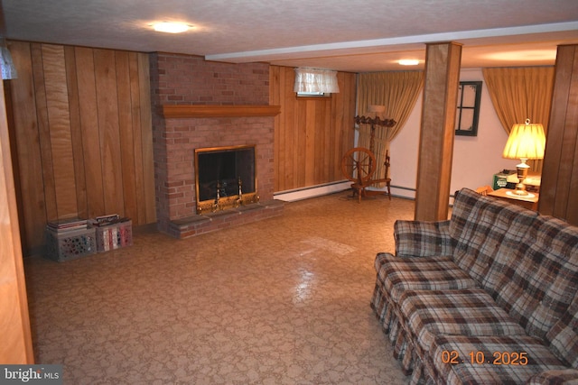 living room with a baseboard heating unit, a fireplace, and wood walls