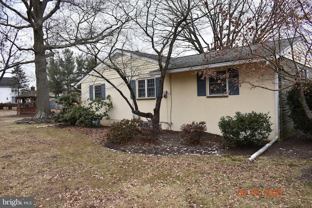 view of property exterior with a yard