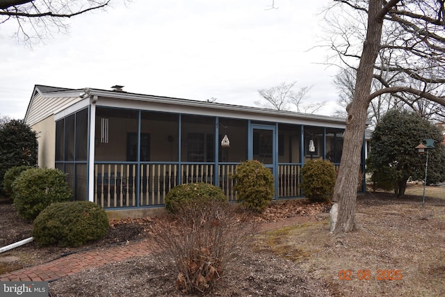 back of house with a sunroom