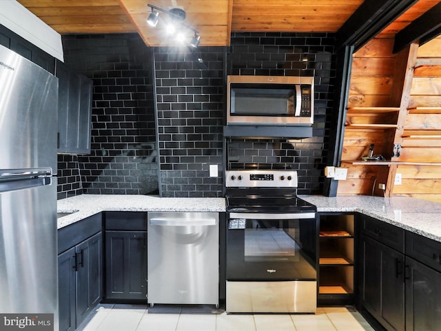 kitchen with light stone counters, wood ceiling, backsplash, and stainless steel appliances