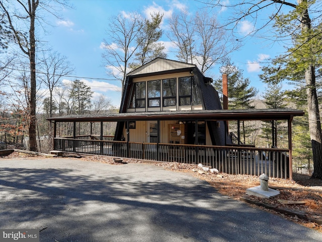 a-frame style home featuring covered porch