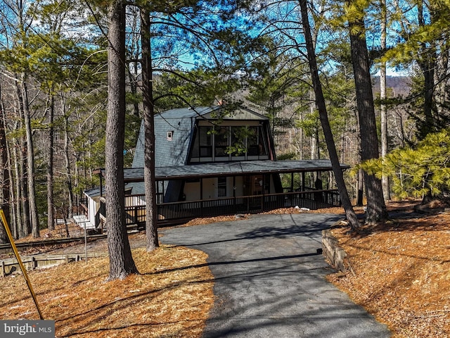 a-frame home featuring roof with shingles and aphalt driveway