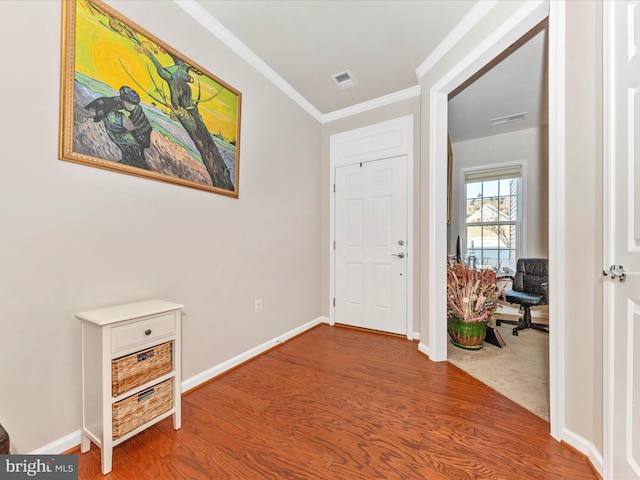 entrance foyer featuring wood-type flooring and ornamental molding