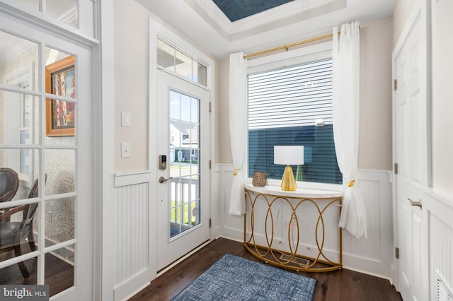 doorway to outside featuring dark hardwood / wood-style flooring and a raised ceiling