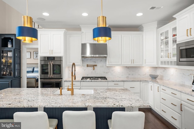 kitchen with stainless steel appliances, a kitchen island, and pendant lighting