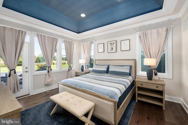 bedroom featuring crown molding, a tray ceiling, dark wood-type flooring, and access to outside