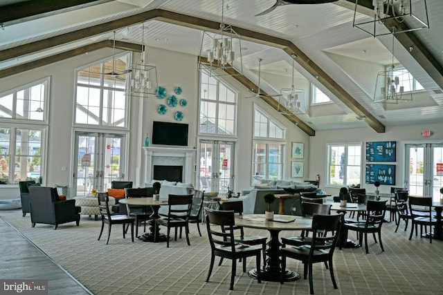 dining area featuring french doors, beam ceiling, and a notable chandelier