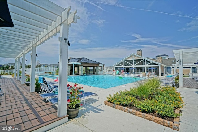 view of pool with a pergola and a patio