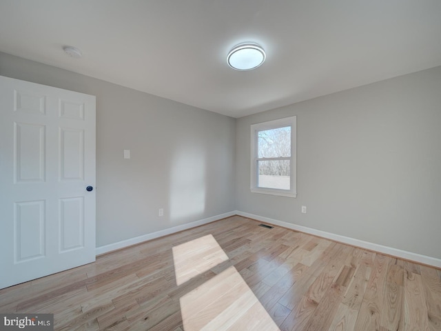 spare room with light wood-type flooring