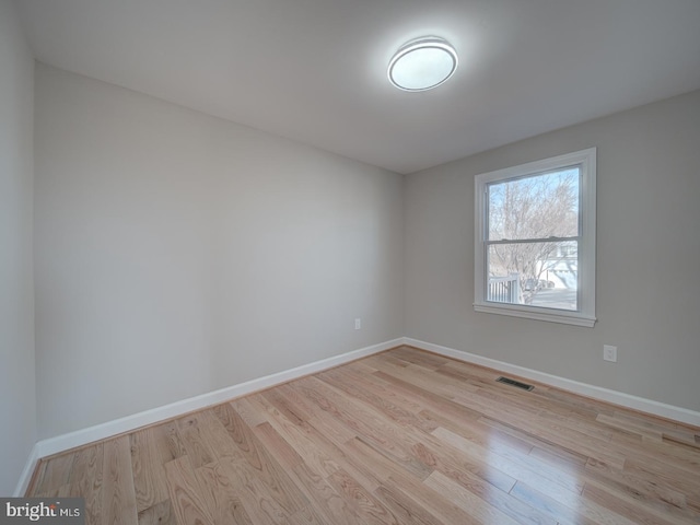 spare room with light hardwood / wood-style flooring