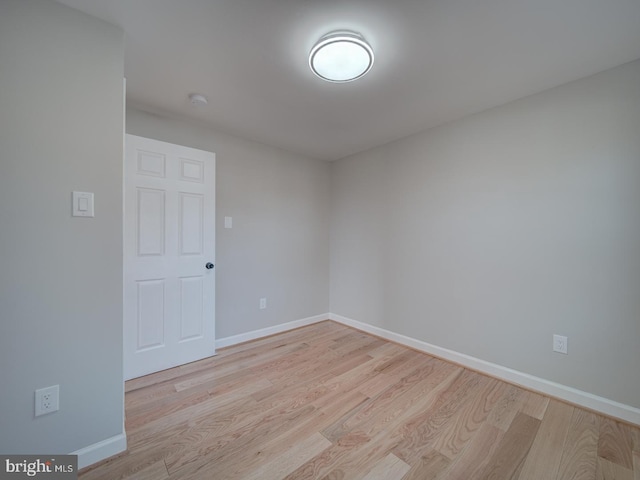 spare room with light hardwood / wood-style flooring