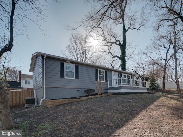 view of front of home with a wooden deck and central air condition unit