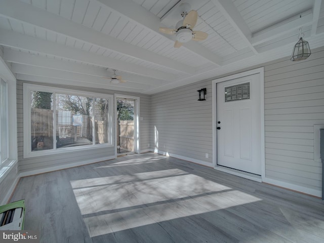 unfurnished sunroom featuring beam ceiling and ceiling fan