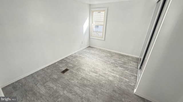 unfurnished room with dark hardwood / wood-style floors