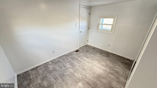 unfurnished bedroom featuring dark hardwood / wood-style floors