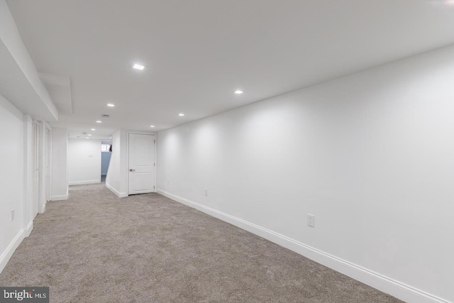 basement featuring light colored carpet