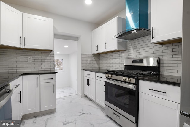 kitchen featuring white cabinets, appliances with stainless steel finishes, decorative backsplash, and exhaust hood