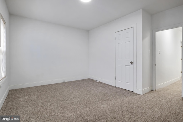 carpeted empty room featuring a healthy amount of sunlight