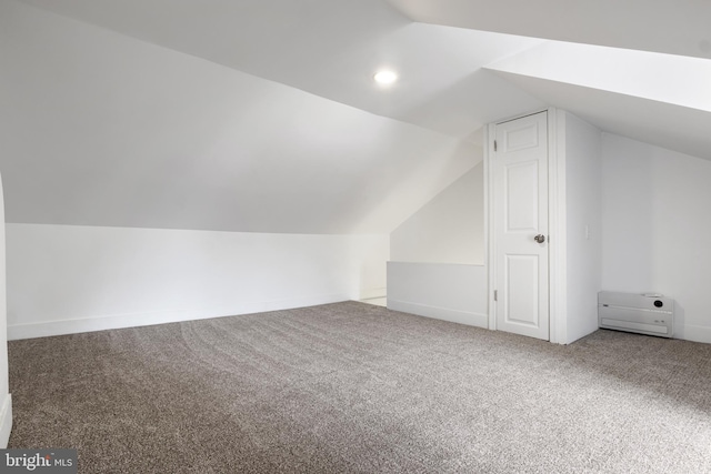 additional living space with lofted ceiling and carpet