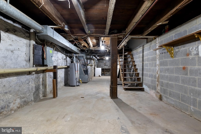 basement featuring electric panel and water heater