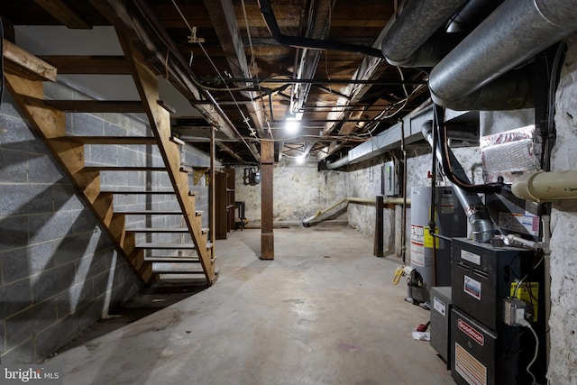 basement featuring gas water heater and electric panel