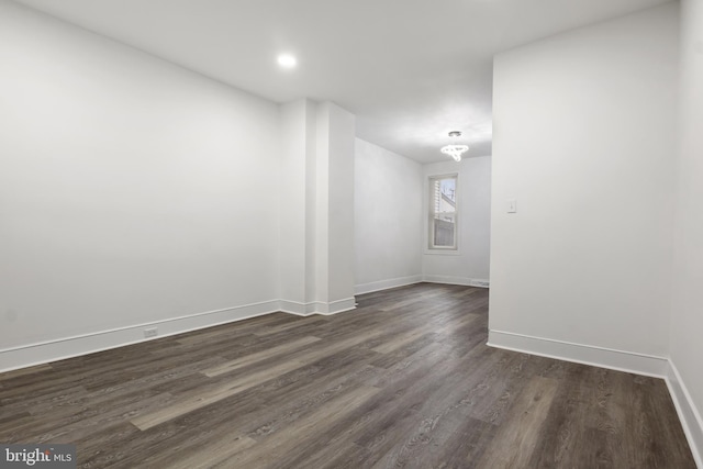 empty room featuring dark wood-type flooring