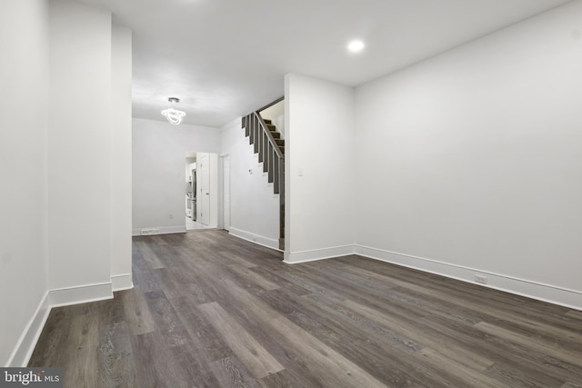 spare room with dark hardwood / wood-style flooring