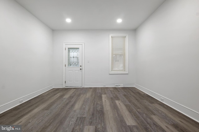 unfurnished room featuring dark hardwood / wood-style flooring