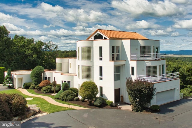 view of front of home featuring a balcony and a garage