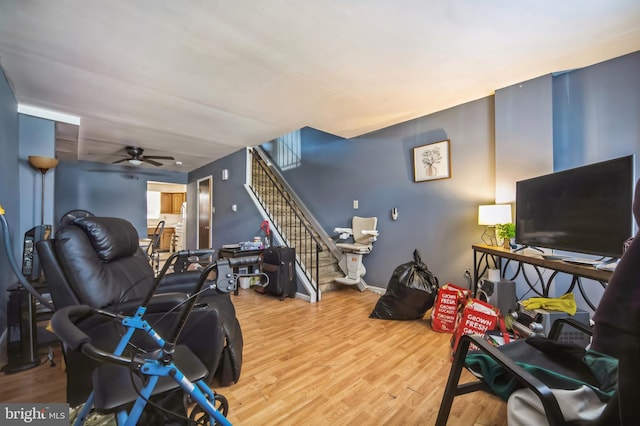 living room with ceiling fan and wood-type flooring