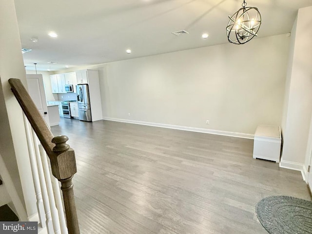 living room with a chandelier and light hardwood / wood-style flooring