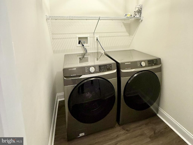 laundry area featuring dark hardwood / wood-style floors and independent washer and dryer