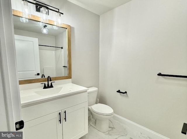 bathroom with vanity, toilet, and a shower