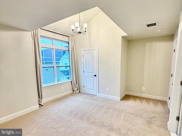 unfurnished bedroom with light colored carpet and a notable chandelier