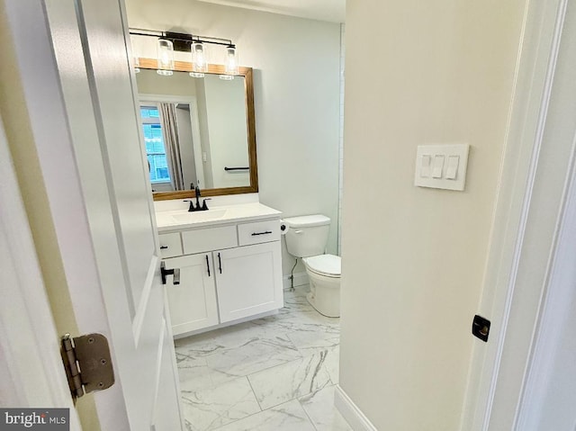 bathroom featuring vanity and toilet