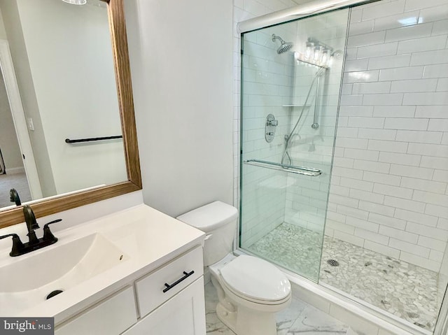 bathroom featuring vanity, toilet, and walk in shower