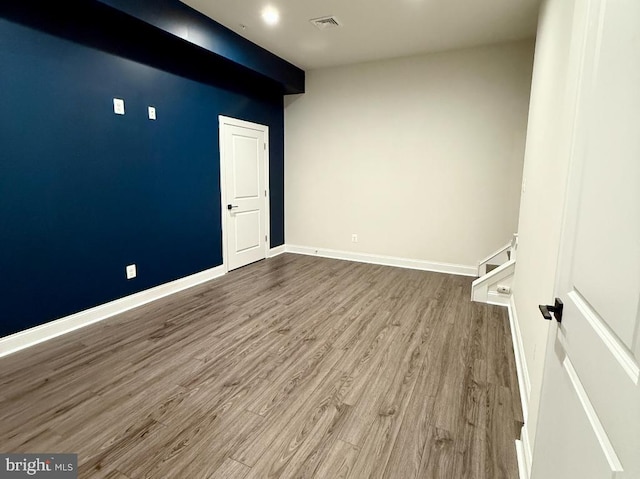 empty room with hardwood / wood-style flooring