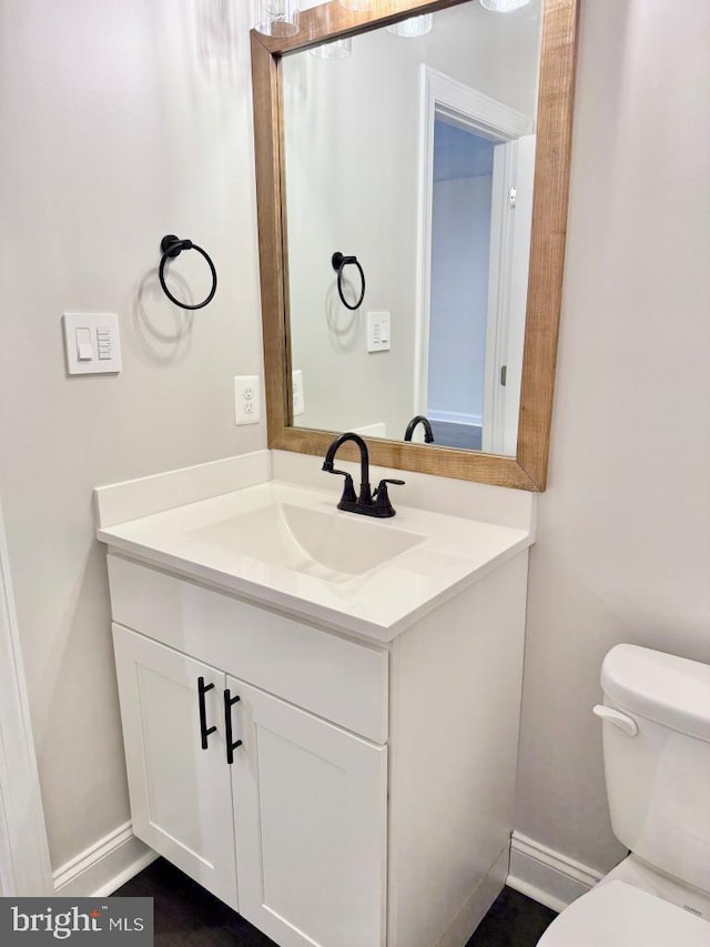 bathroom featuring vanity and toilet