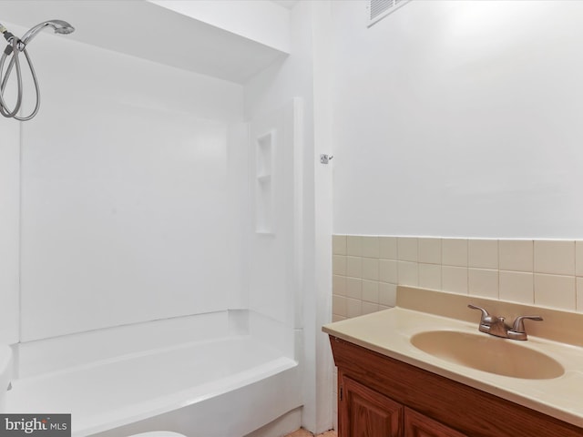 bathroom featuring tile walls, vanity, and a bathing tub