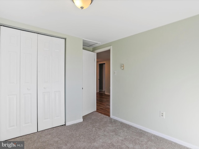 unfurnished bedroom featuring a closet and light colored carpet