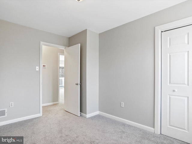 unfurnished bedroom featuring light colored carpet