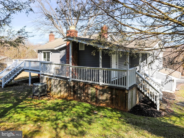 view of home's exterior featuring a deck and a lawn