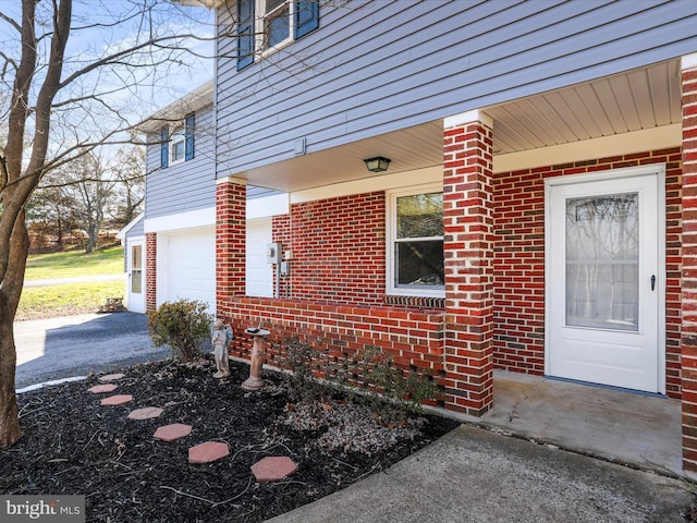 view of exterior entry with a garage