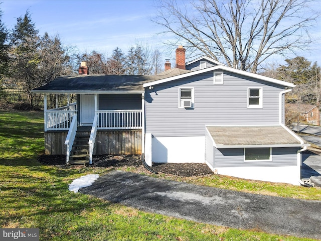 view of home's exterior featuring a yard and covered porch