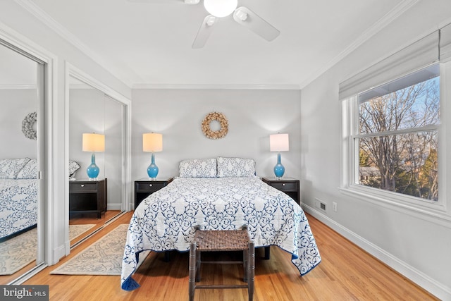 bedroom featuring crown molding, baseboards, and wood finished floors