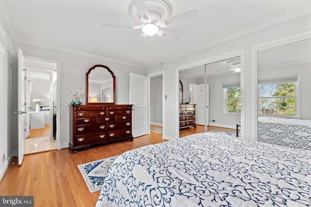 bedroom featuring ornamental molding, baseboards, light wood finished floors, and a ceiling fan