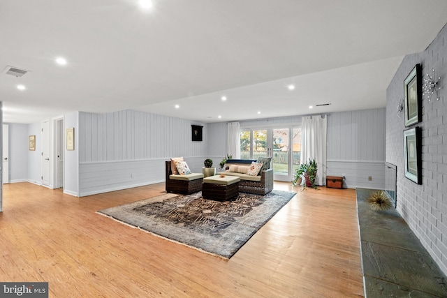 living room with light wood-type flooring, visible vents, and recessed lighting