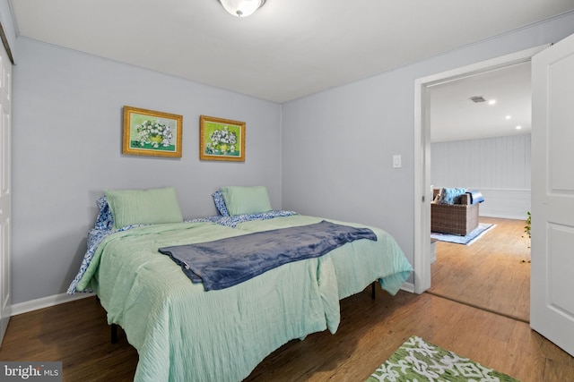 bedroom with baseboards and wood finished floors