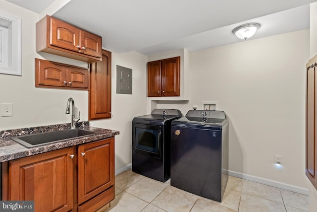 laundry area with cabinet space, washing machine and dryer, light tile patterned flooring, a sink, and electric panel