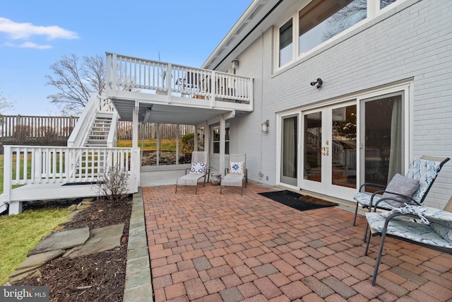 view of patio / terrace with stairs, french doors, and a wooden deck